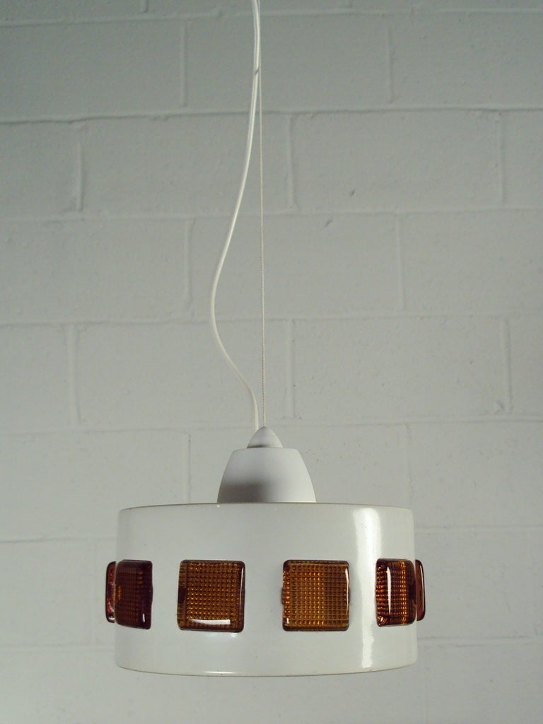 Vintage Mid-Century Swedish Modern Pendant in a cloud white enamel coated finish with amber colored glass tiles. Newly rewired to US standards.