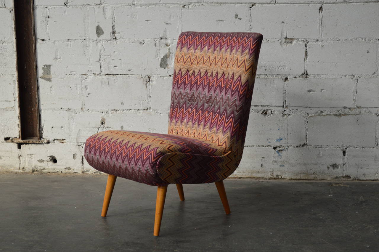 This fantastic Mid-Century accent chair has been reupholstered in a durable sunbrella fabric giving it a Missoni-esque look. It also features a hidden drawer perfect for small space living.