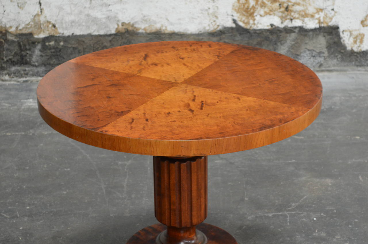 Swedish Art Deco round pedestal table. The tabletop is paneled flame birch. It is the perfect size beside a club chair, at the end of a sofa, or as a very stylish bedside table.