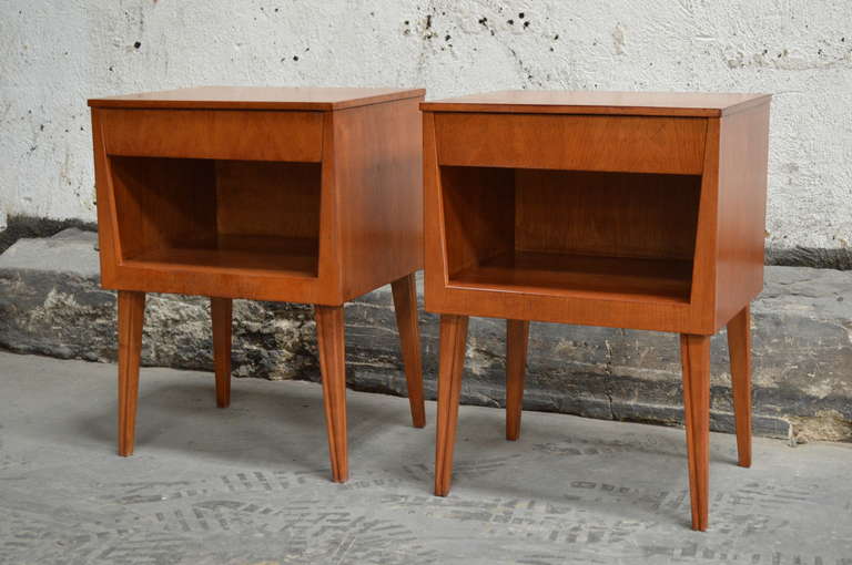 Pair of Swedish mid century modern teak nightstands, freshly refinished. Each table has one drawer and an open shelf atop classic mid century legs.