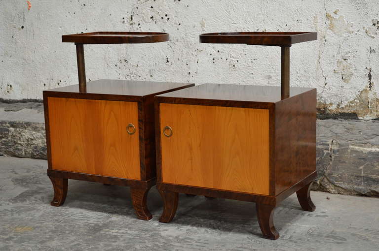 Pair of rare Swedish art deco nightstands. Interesting cabinet base with a unique swivel shelf on top. Beautiful curved detailed legs and original brass ring pulls.

Base is 17