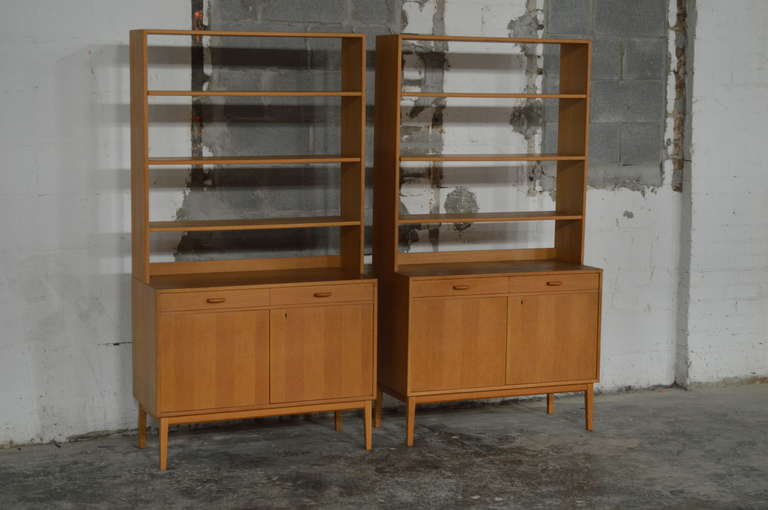 Rare Pair of Swedish Mid-Century Modern Storage Bookcases. Beautiful vintage bookcases with locking doors on the bottom with ample storage space and two adjustable shelves and two drawers. Shelves on the top are adjustable 

Very functional and