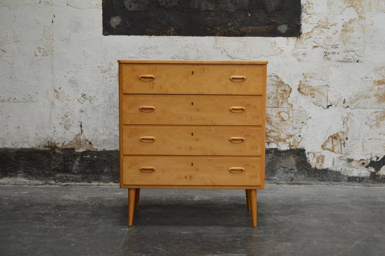 Swedish Mid-Century modern four drawer chest of drawers of light birch. Atop round tapered legs and modern inset pulls. Handsome and perfectly scaled for many different uses. Sweden, c.1950's