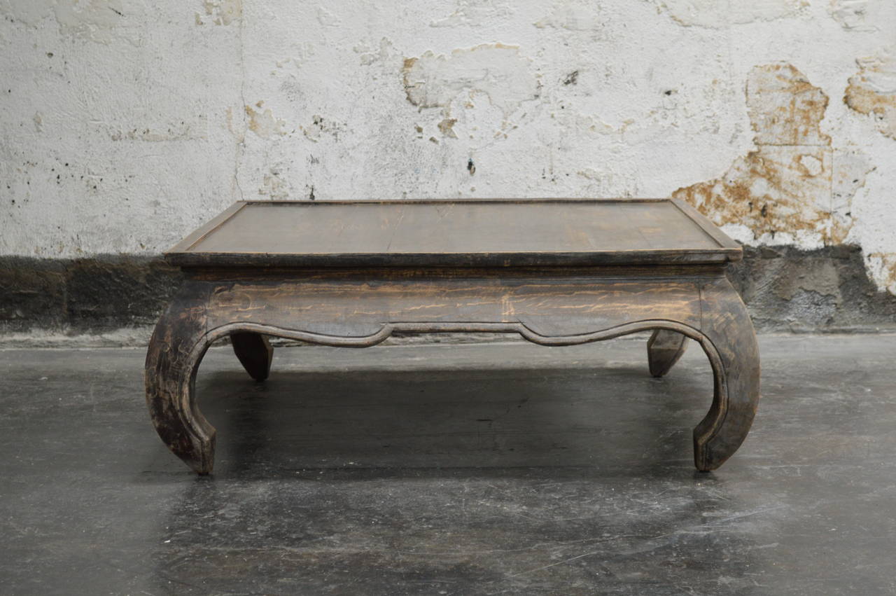 Vintage square opium leg coffee table with original distressed weathered finish. Very handsome. Exceptional detail with carved and sculpted legs.