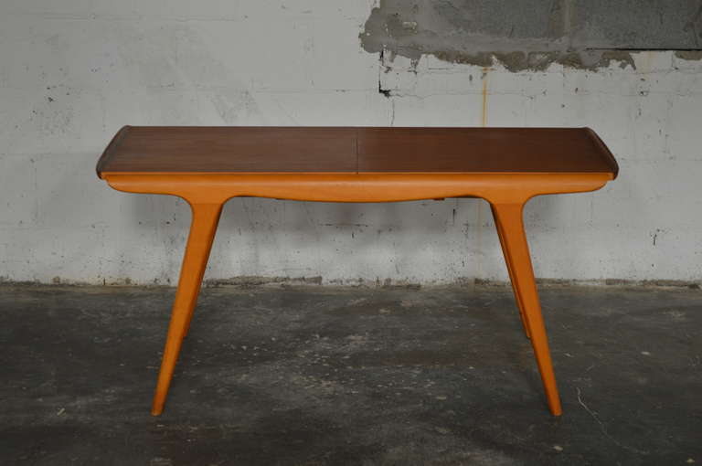 Versatile coffee table made of birch and teak with sliding top to reveal a black laminate surface for dining. Table expands to 67