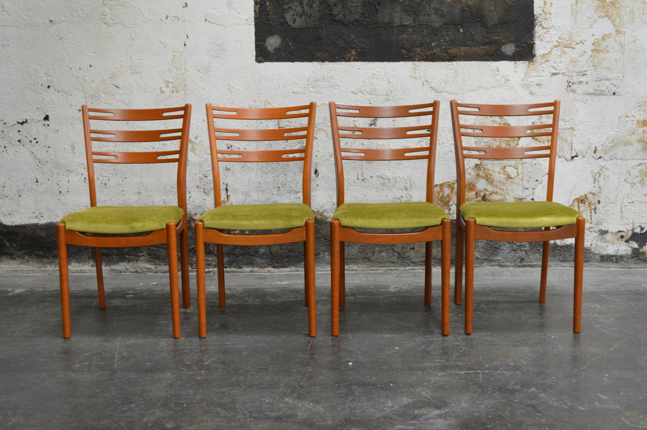 Set of four stylized teak dining chairs from circa 1960, Sweden. Newly restored and upholstered in chartreuse silky velvet.