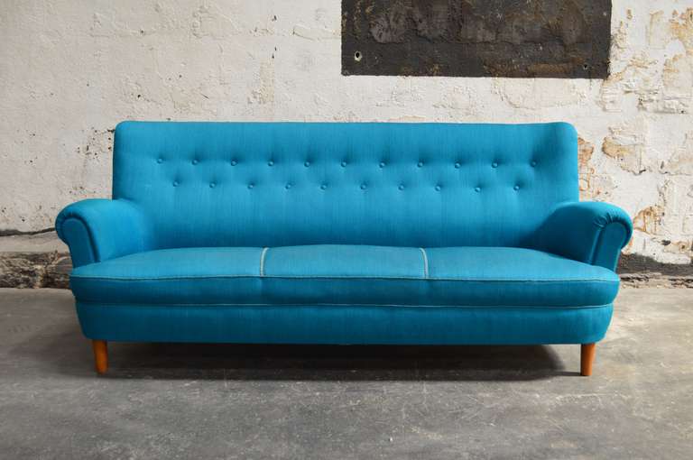 Swedish Hemmakvall sofa by Carl Malmsten in original turquoise wool fabric circa 1956. Very comfortable! While the original upholstery fabric is extremely fabulous, it does retain a slight musty odor. Price listed includes reupholstery in COM.