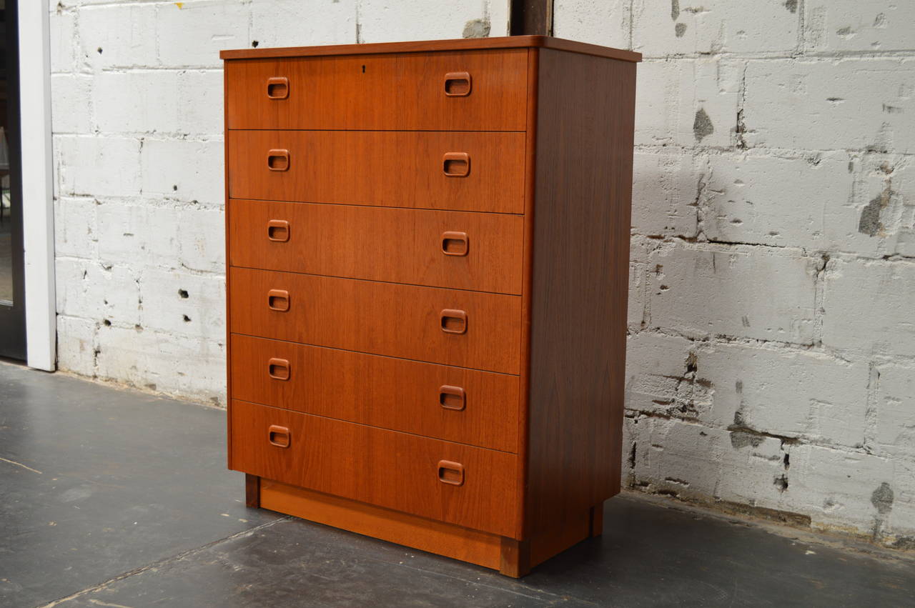 Unusually tall Swedish chest of drawers in a rich toned teak with six spacious drawers adorned with eye catching handles.