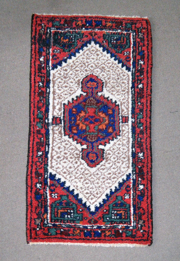 Beautiful vintage Persian wool rug with vibrant shades of blue, red, ivory, sage and black. In good overall condition but does show some signs of wear.