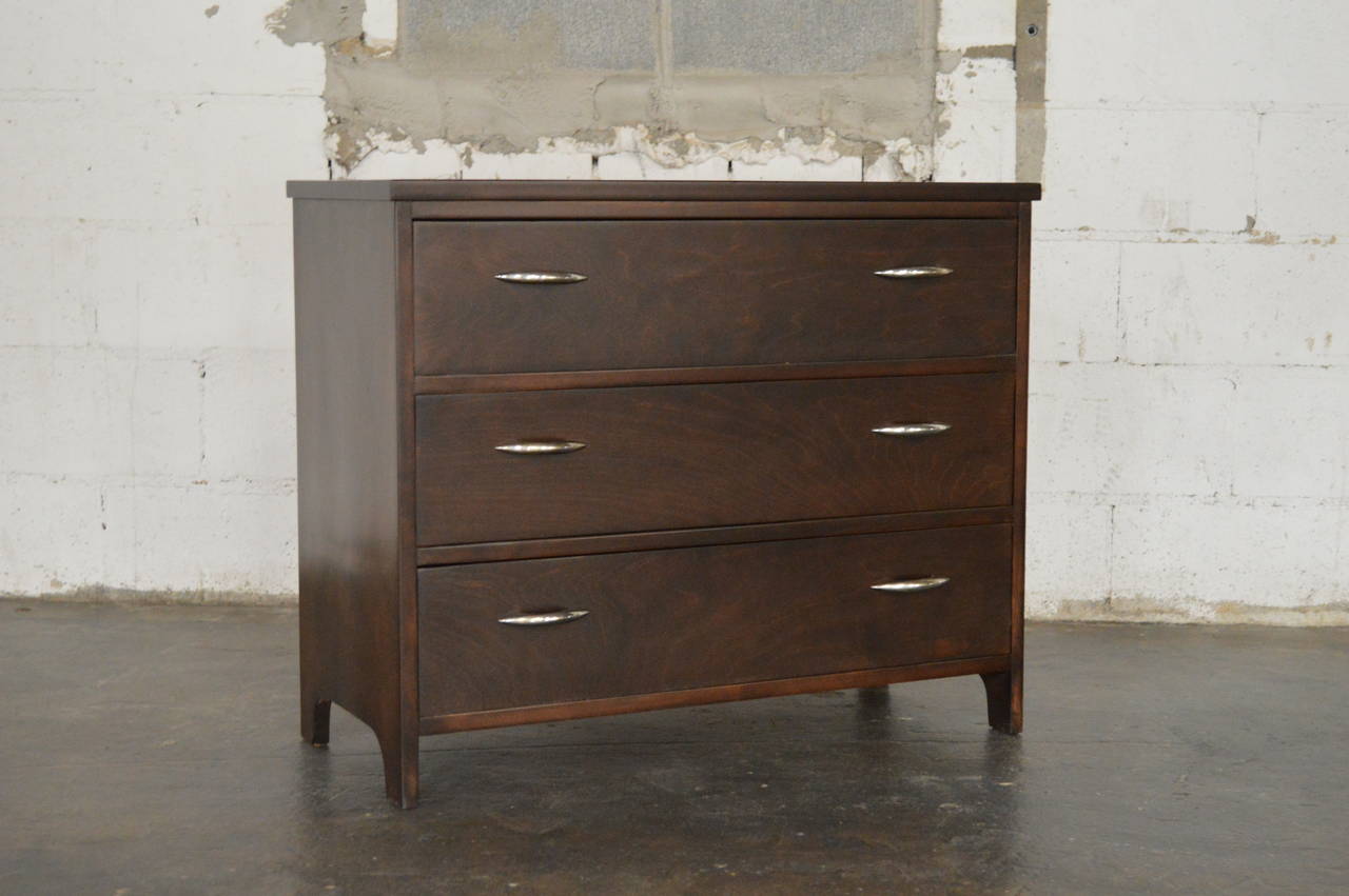 Mid Century Modern Chest of Drawers made of Birch in Sweden. Chest of dawers has an espresso finish with chrome drawer pulls. There are three drawers with ample space. Perfectly scaled for many different uses and could be placed in a bedroom, dining