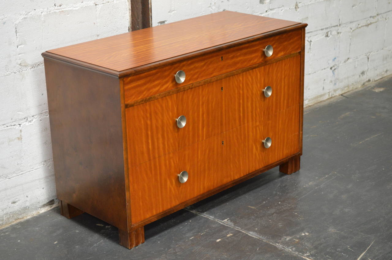 Swedish Art Deco chest fitted with three spacious drawers in beautiful mahogany with flame birch sides and legs. This chest has nickel pulls. Perfectly scaled for just about anywhere in the home.