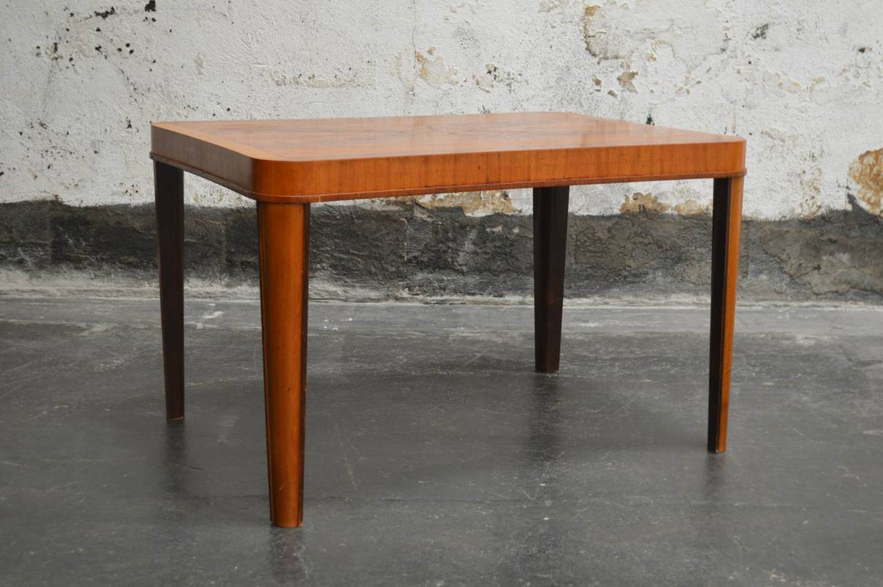 Art Moderne Deco concave table with playful matchbook walnut for use as a side or coffee table, 1930s. Inlaid with rosewood. Recently refinished and Swedish polished.