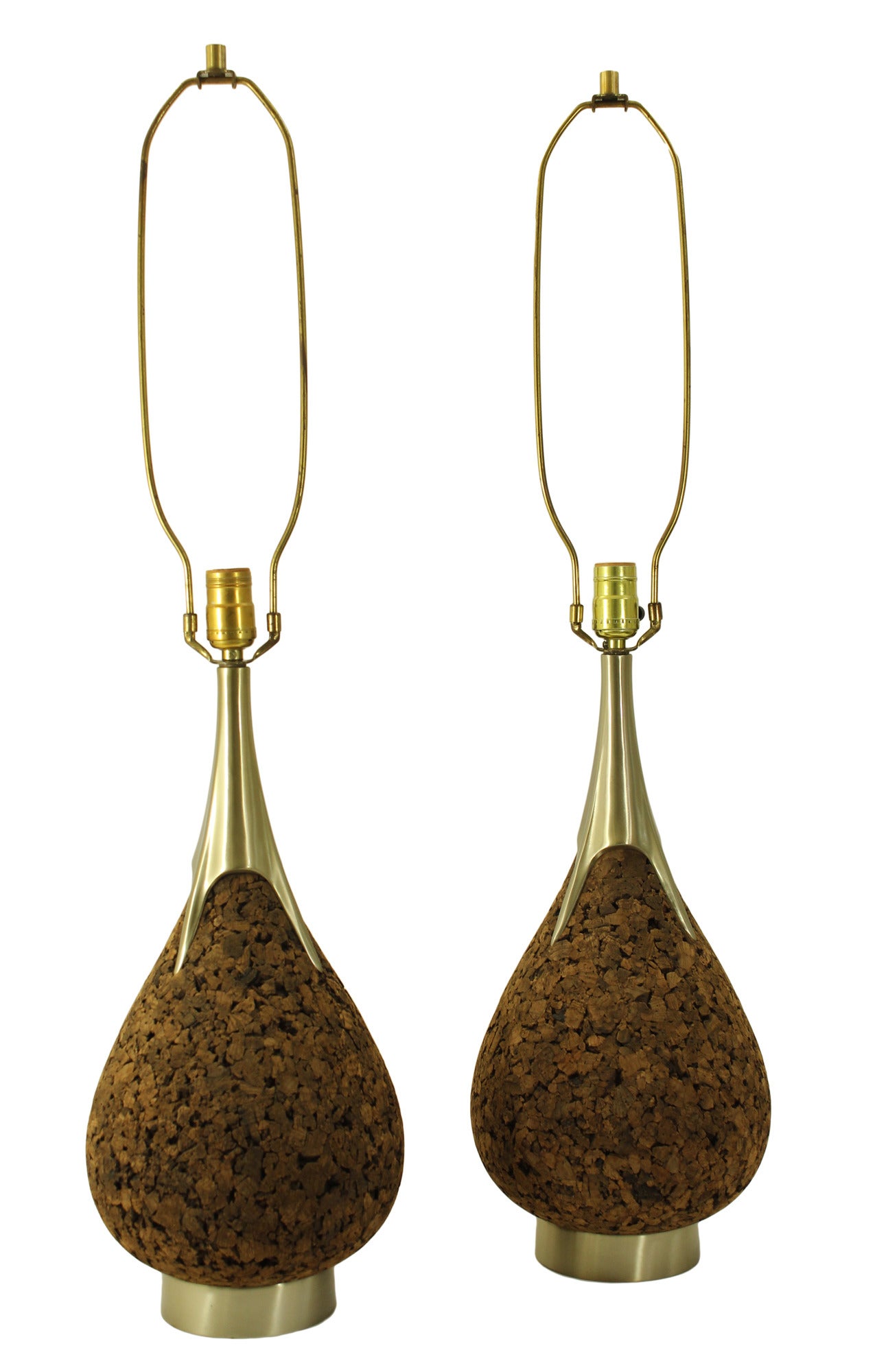 A pair of large Mid-Century Modern cork teardrop lamps from laurel featuring heavy solid brass castings at the top and base. In very good working condition with virtually no signs of wear except to the upper hardware parts (harps and finials) which