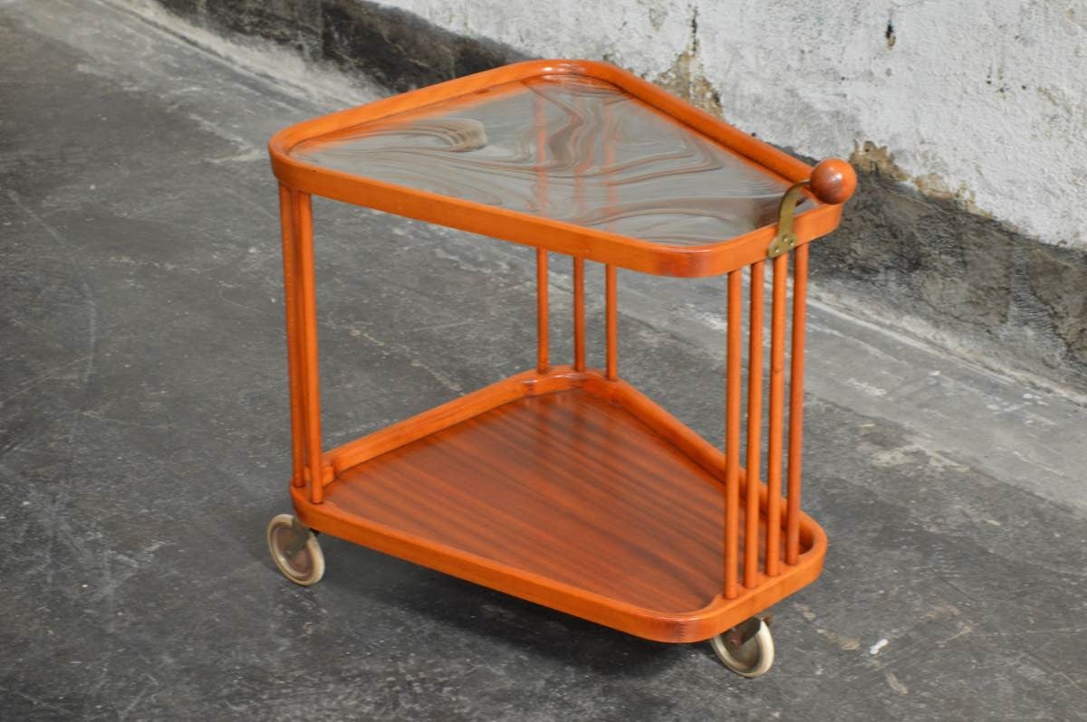 A bar cart, design attributed to Axel Larsson for Bodafors.
Sweden, circa 1940s.
Original casters and wood finish. The glass is later addition and is purely decorative. A stronger, more functional piece of clear glass can be cut and purchased if to