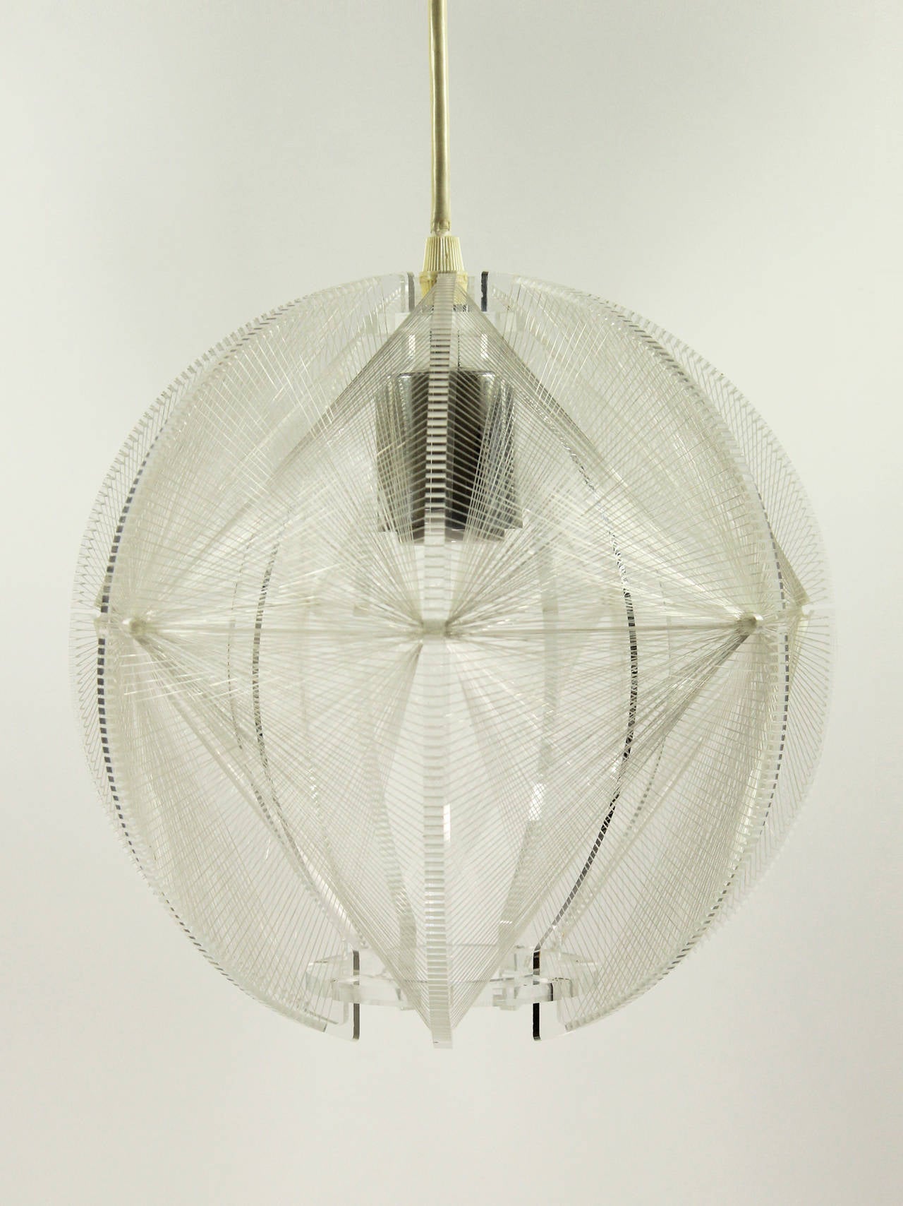 This dazzling 1970s pendant from West Germany consists of a round Lucite frame with seven protruding notched fins that are intricately interwoven with nylon string. Fixture comes with a ceiling canopy and a light bulb of the correct size and shape.