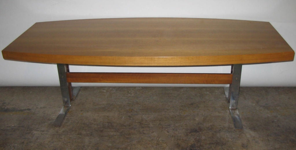 MCM Swedish coffee table crafted of rich teak on a chrome base.  Note the pull-out laminate shelf on one side.  Very heavy and in terrific condition.  Dated 1961.