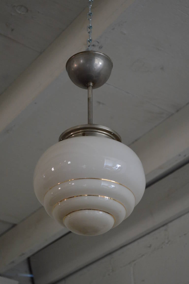 Swedish industrial Deco pendant light fixture. Chrome pole with stepped glass shade trimmed with gold. This was likely originally a flush mount fixture converted to a pendant style but can be changed back if preferred.