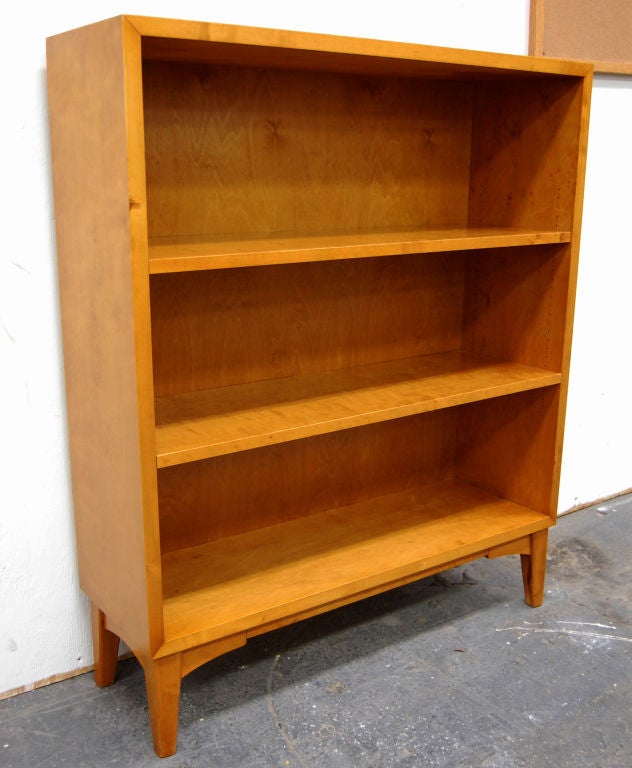 Handsome bookcase crafted of golden flame birch.  Shelves are adjustable.  As shown - the shelves are approximately 10 inches apart and are held sturdily in place with hidden wire brackets.