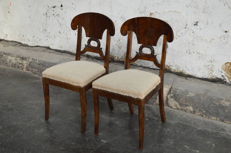 Pair of Swedish Biedermeier side chairs of dark flame birch with shovel-shaped backrest and decorative wreath center bar. Ready to be upholstered in your COM fabric. Price includes upholstery.