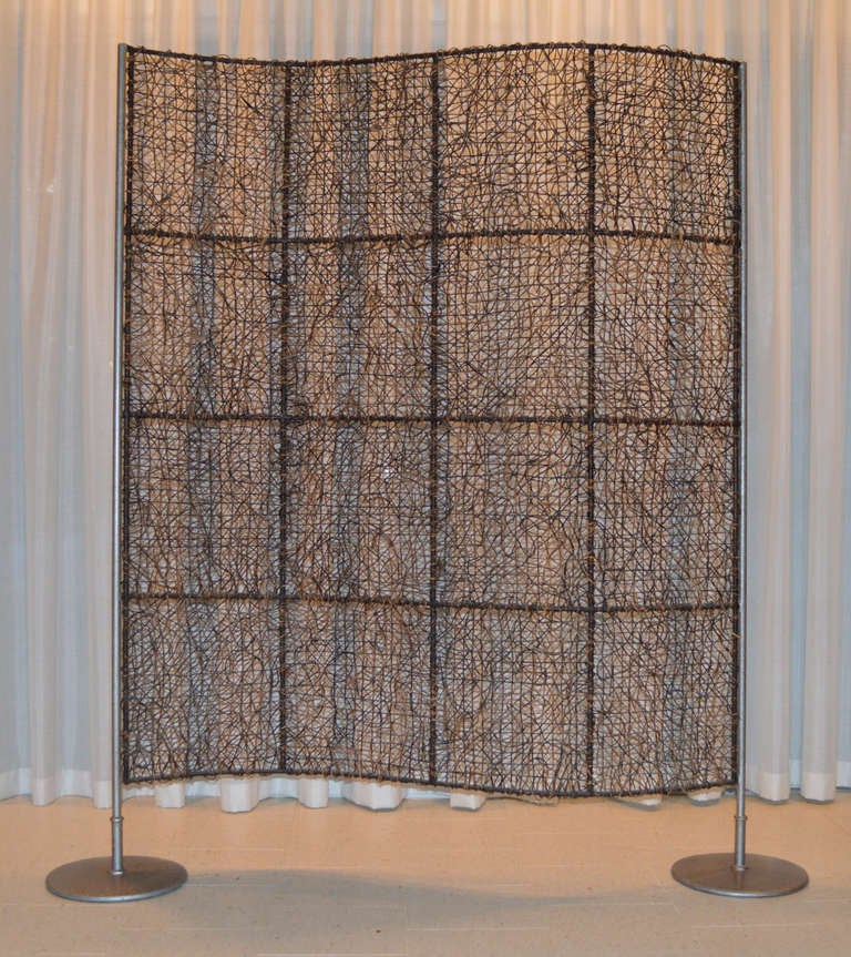 Vintage Woven Luminary Wave Screen Room Divider. Woven hand-dyed reed on heavy metal bases. The wave profile & organic weaving pattern creates a dappled shadow pattern when light shines through it.