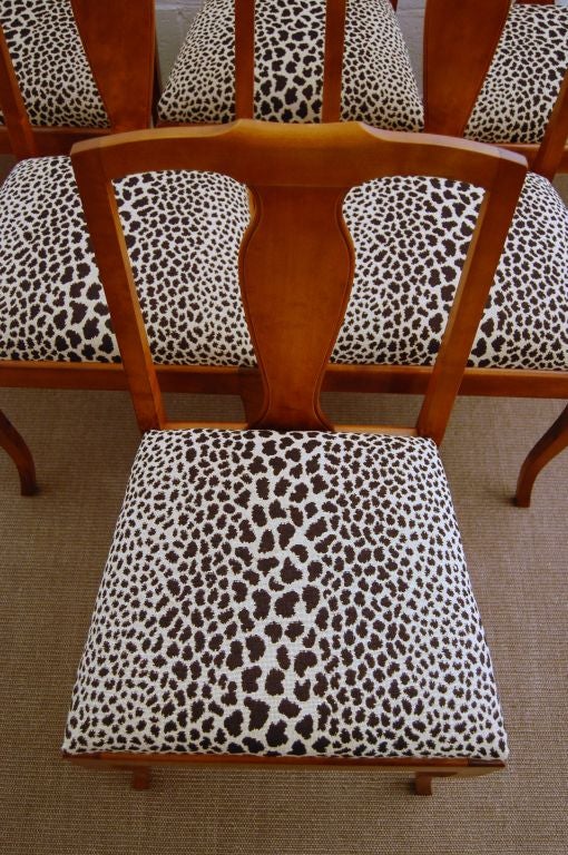 Set of six fun and elegant dark golden flame birch dining chairs.  Newly restored and newly rebuilt with new padding, covered in a durable woven black and ivory Cheetah stripe fabric.