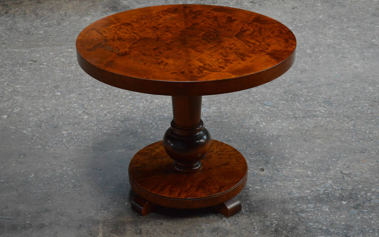Swedish round pedestal end or side table of flame birch. Beautifully simple Art Deco pedestal base. Perfect scale to be used as a bedside table or next to a sofa or chair in a living room.