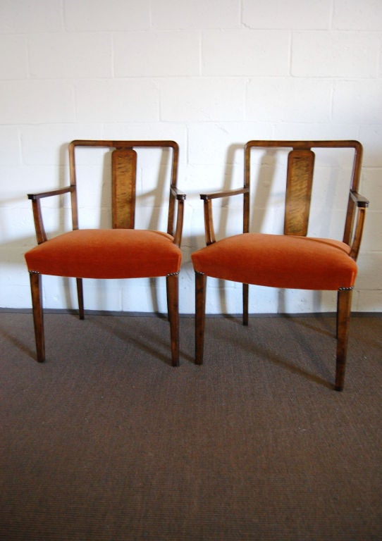Pair of Swedish Art Deco armchairs with intarsia (inlaid) back harp. Newly reupholstered in rich burnt orange mohair velvet and trimmed with two-tone brass finish Renaissance nail heads. Extremely comfortable and roomy, these chairs make for great