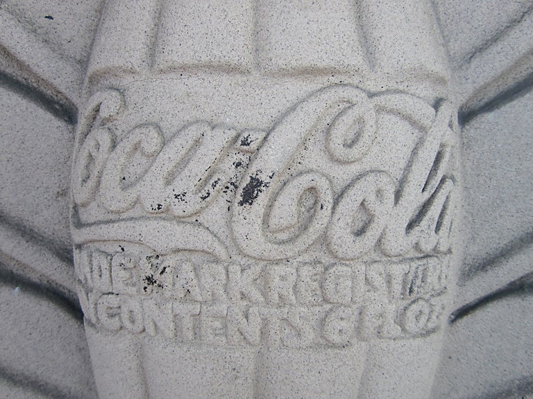 Circa 1900 cast concrete Coca Cola architectural fragment showing the iconic bottle, cap and logo with fancy and sculptural fan detailing behind the bottle, taken from the cornerstone of the Milwaukee Wisconsin Coca Cola bottling plant, all in