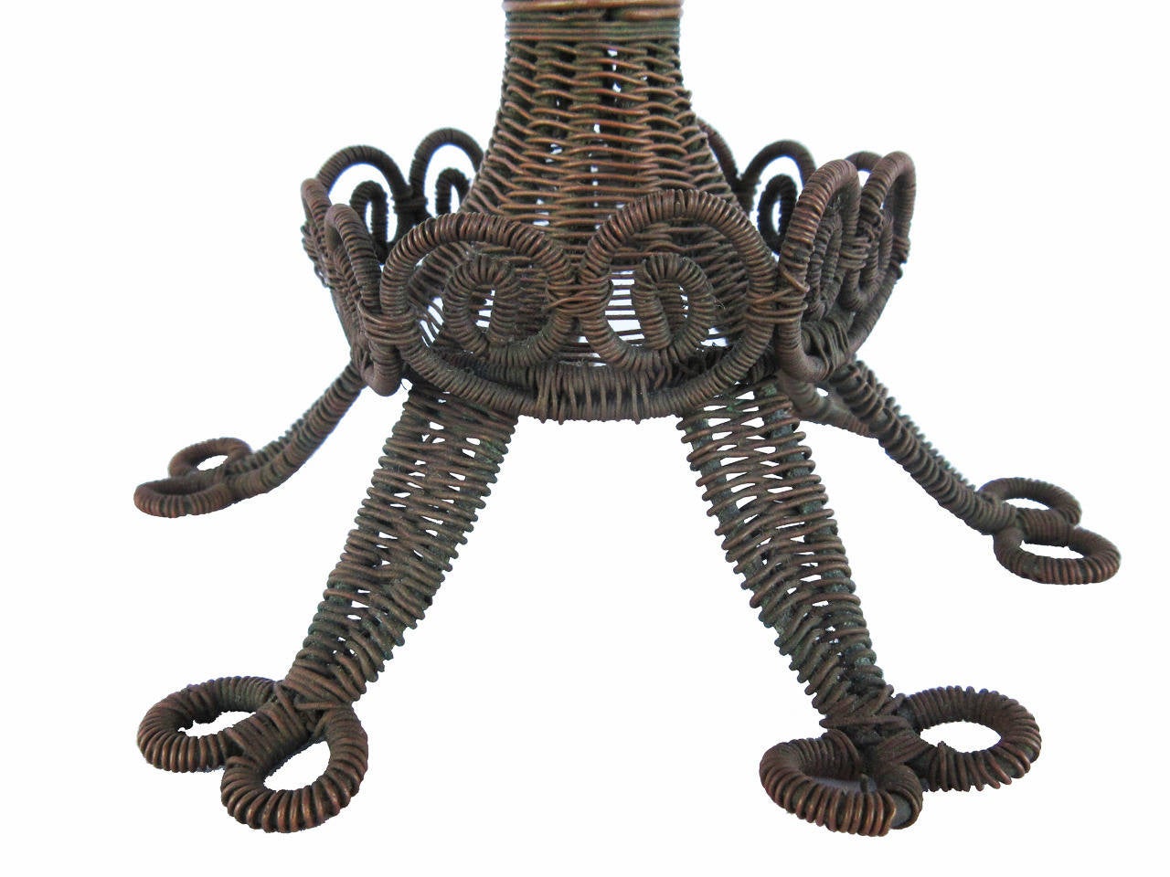 Wire compote with exceptional detailing showing fancy drop springs at the top, curlicue detailing on base, all standing on double circled feet, constructed from Model T copper coil wires and made by Peter Wing of Hawk Point MO, untouched surface and