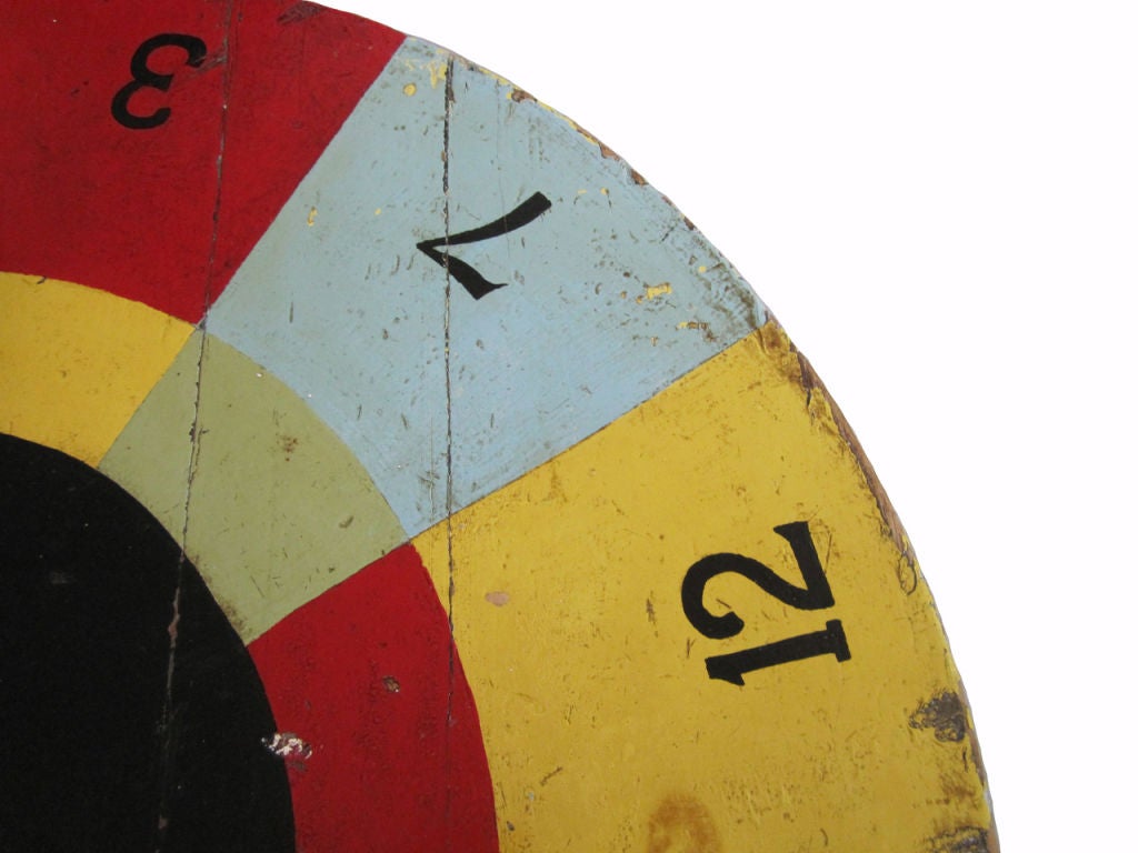 Circa 1930 solid wood game wheel with vibrant and graphic multi colored squares, wood arrow indicator, original painted surface