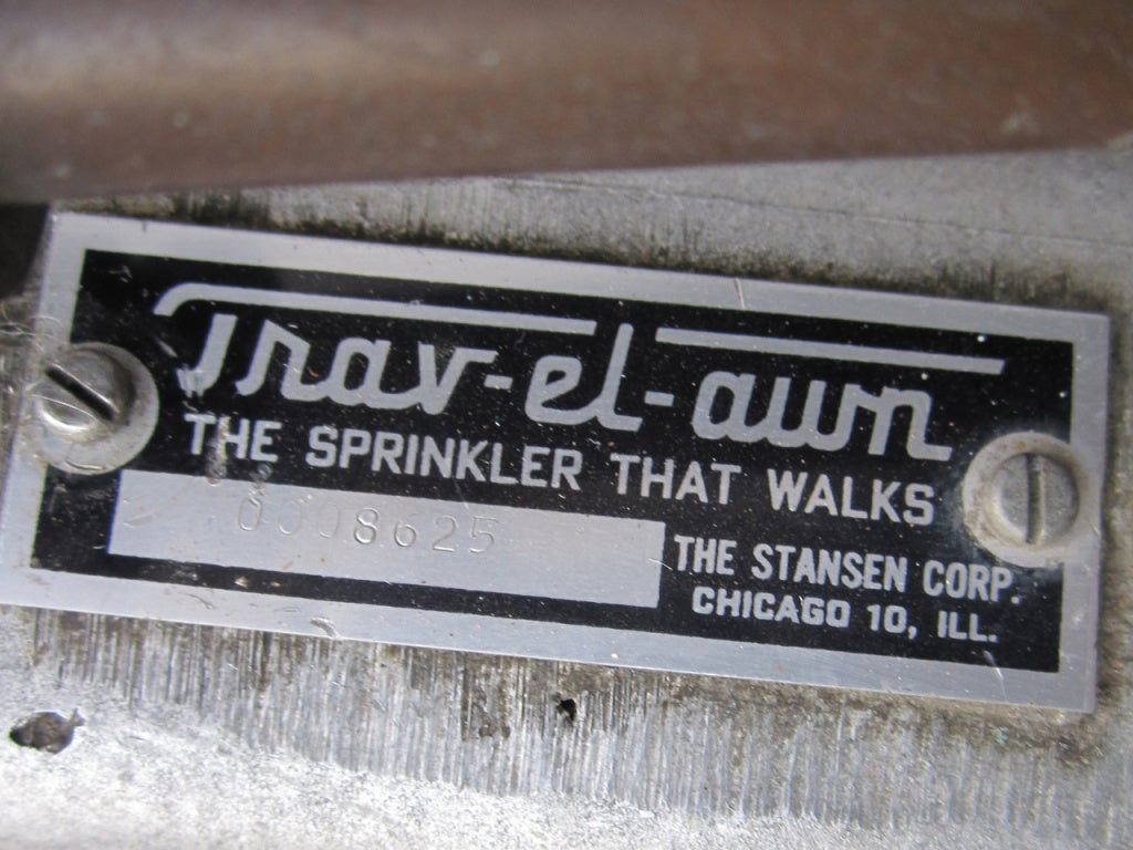 Circa 1930 industrial cast iron walking sprinkler in unusual form, marked 'Trav-el Lawn The Sprinkler That Walks The Stansen Corp, Chicago Ill' all in original silver and red paint