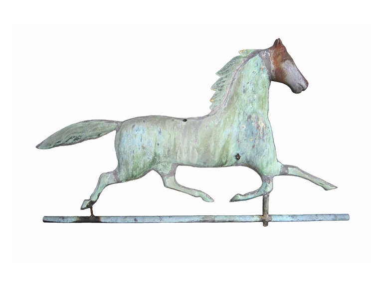 Late 19th century Ethan Allen copper running horse weathervane with a cast iron head, all in exceptional and untouched original surface and patina, two bullet holes intact, new wall and table brackets included.