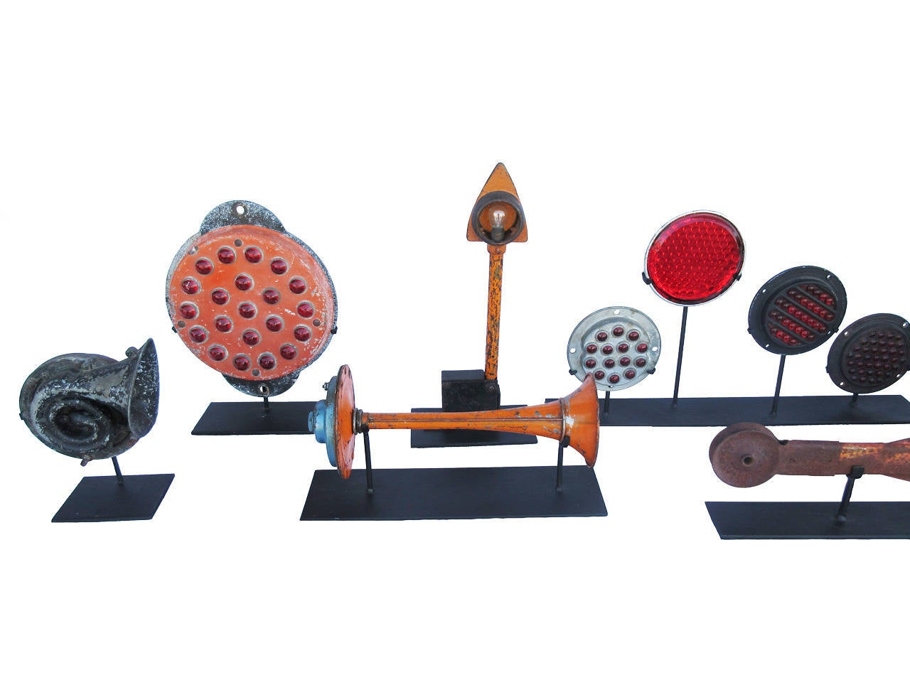 Grouping of eight stands of multiple automobile turn signals, reflectors and horns, all in old painted surface, excellent condition, all mounted on contemporary stands, various sizes, priced for the grouping, circa 1930.