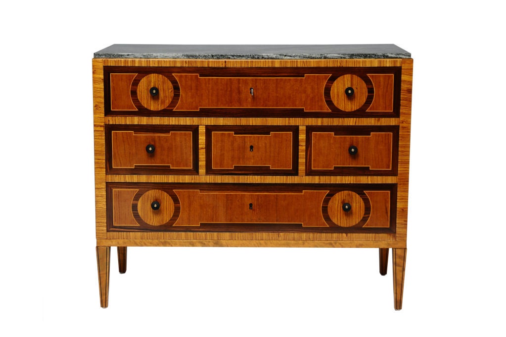A Ture Ryberg commode, Circa 1920-1930<br />
Produced by: <br />
J.E.Blomquist Mobelfabrik, Uppsala, Sweden.<br />
<br />
Rosewood, walnut and birch with geometric inlay and Kolmards marble top. Bakelite and brass pulls. <br />
This model of