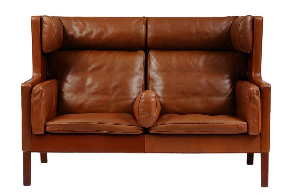 A Danish two person high back leather settee with mahogany legs. Circa 1965-68<br />
<br />
Designed by Børge Morgensen for Fredericia Stolefabrik. <br />
Model 2192<br />
Model name: - Kupé (compartment)