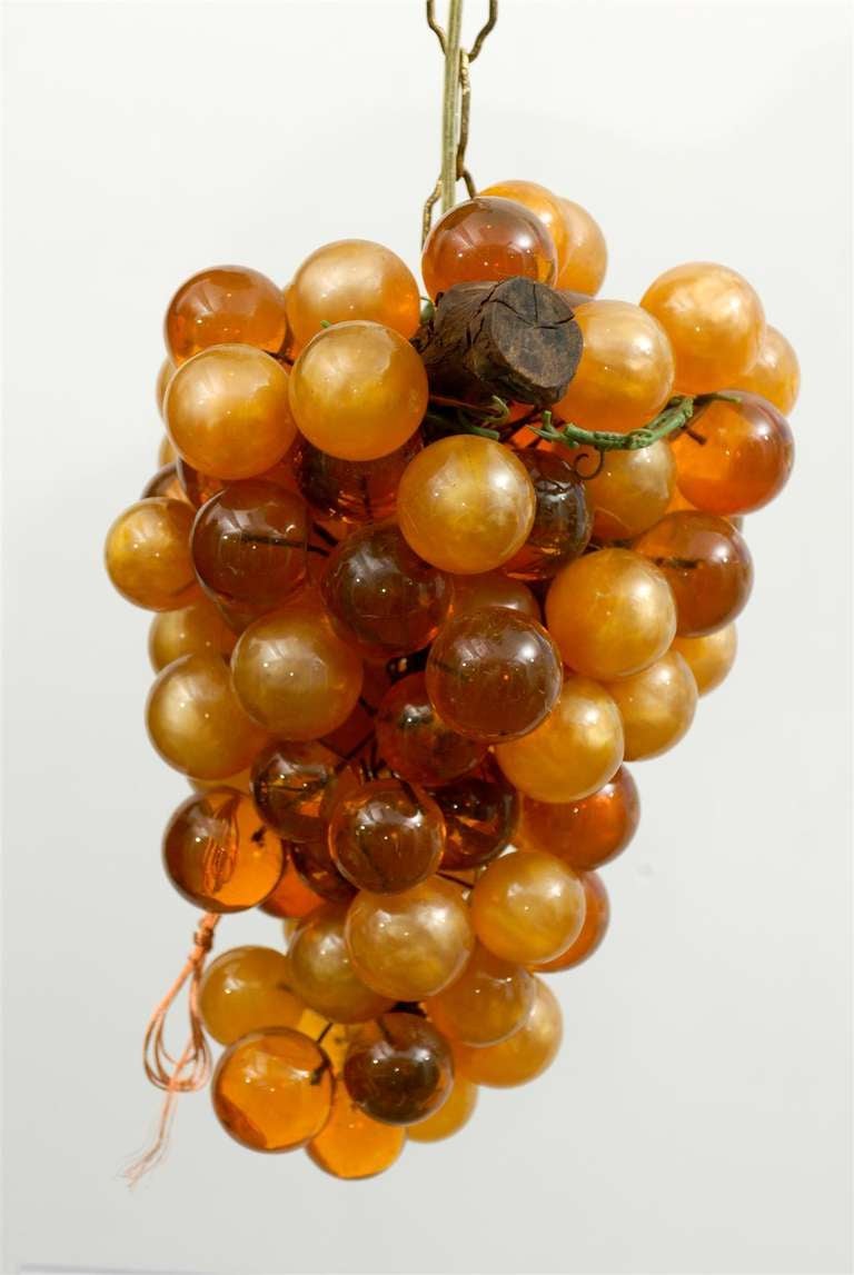 1970s Amber Lucite grape chandelier wired and lit from inside with three lights. 

Approximate size is 14