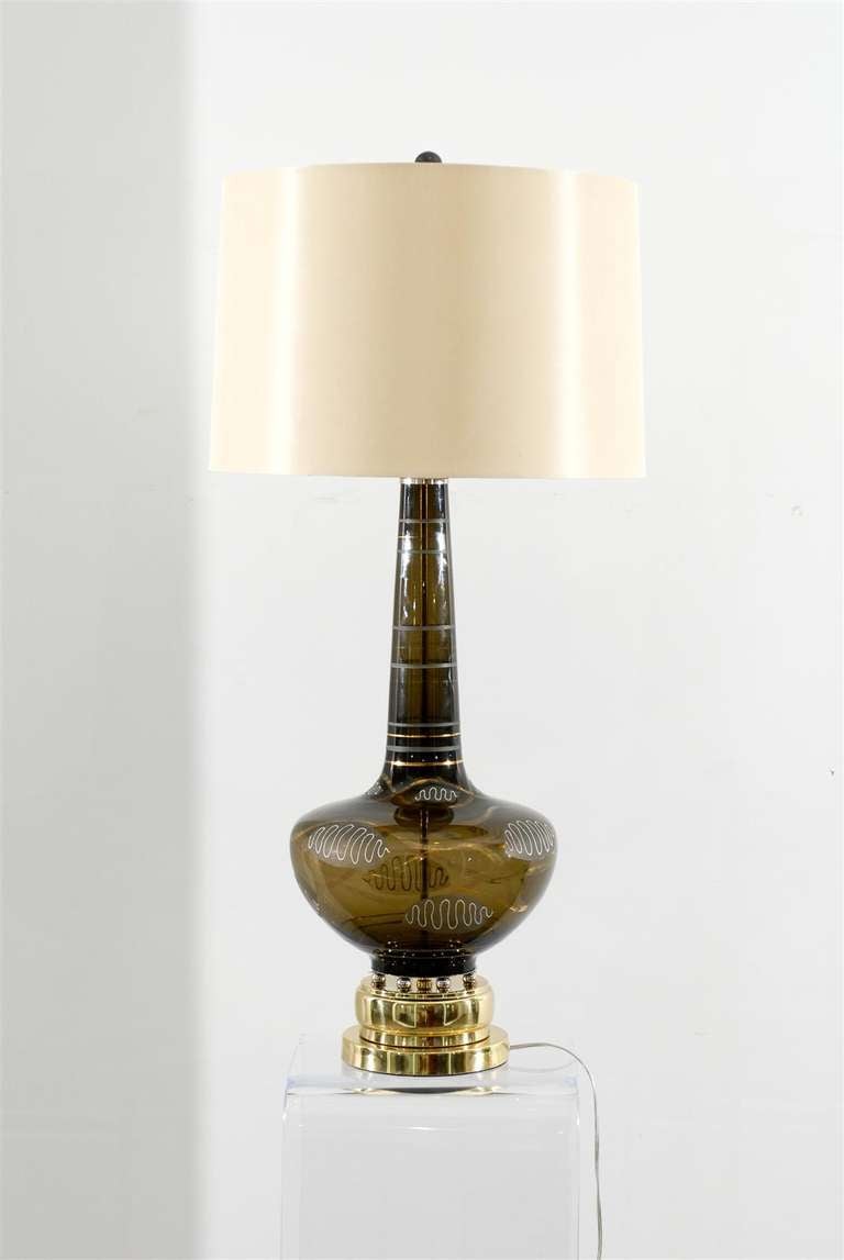 A stellar pair of large scale smoked glass lamps with wonderful hand painted detail. Beautiful brass and nickel accents complement the painted motifs. Exquisite Jewelry ! While the pieces are unmarked, they are reminiscent of Italian lighting
