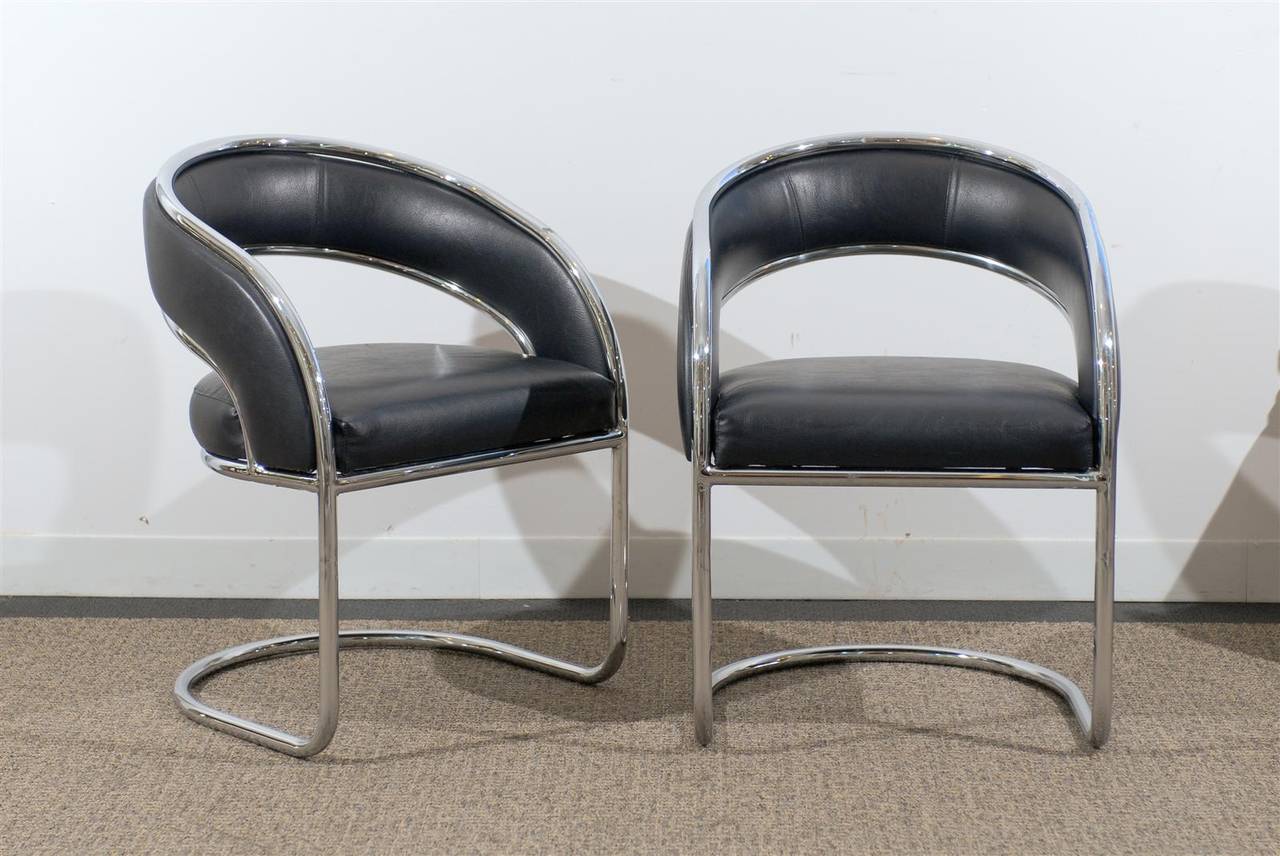 Chic pair of Mid-Century Modern rounded back chairs in chrome upholstered in soft black leather.

Priced noted is for the pair.