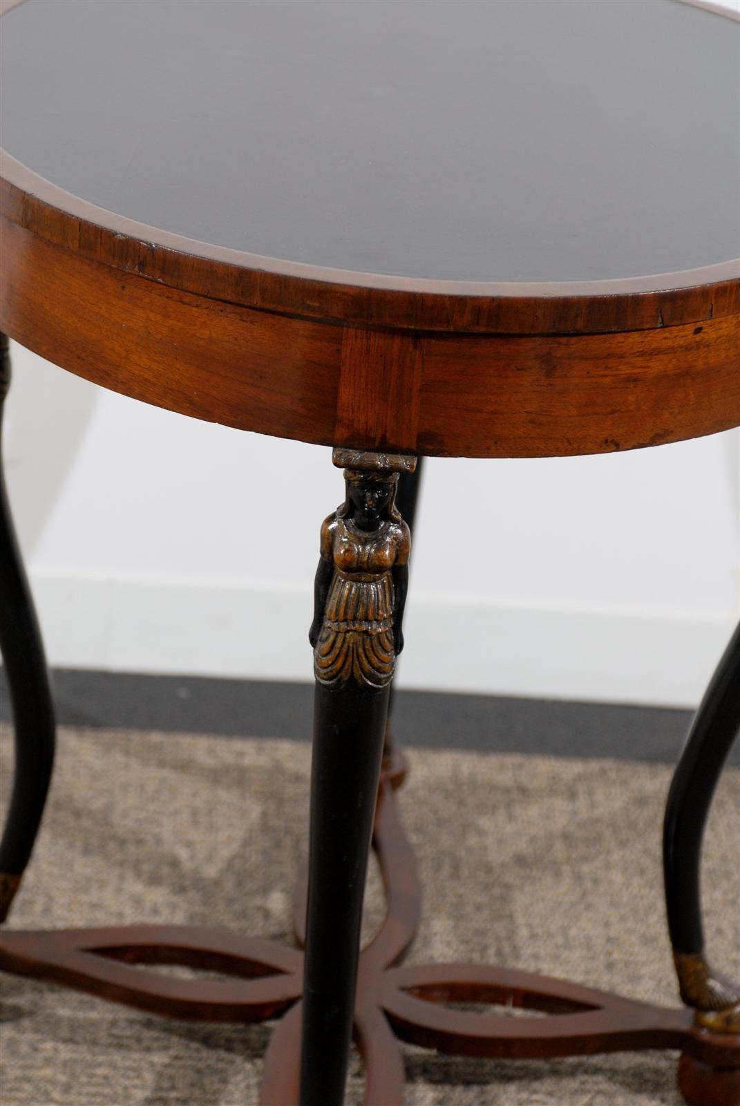 Wood Oval Neoclassical Style Table Raised by Carved Figures For Sale