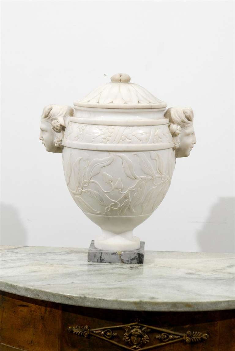 Beautiful 19th Century Italian Marble Urn With Lid.With Carved Heads and vines on a gret marble base.