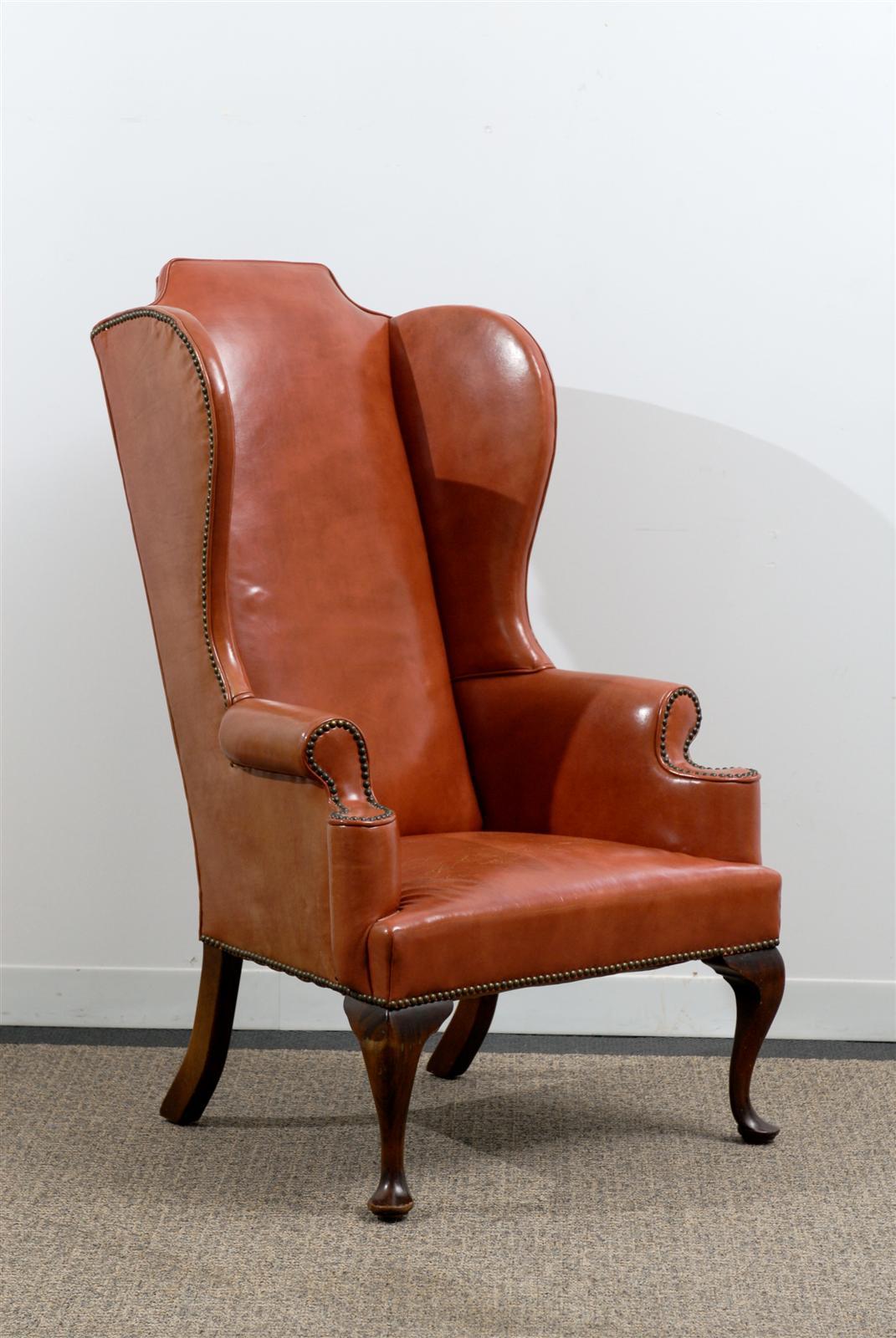 Vintage Orange Leather Wing Chair with Nail Head Trim. Exaggerated Form and beautiful lines. Specifically ordered in the late 1960`s for a Private residence in Atlanta.