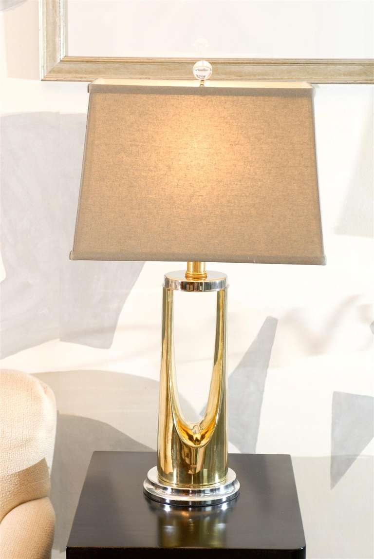 An exceptional pair of modern lamps in polished nickel and brass, circa 1970's. Beautiful, high impact jewelry ! Excellent restored condition. Rewired using clear cord, new 3-way sockets.  Complete with new gray linen shades ( size: 14