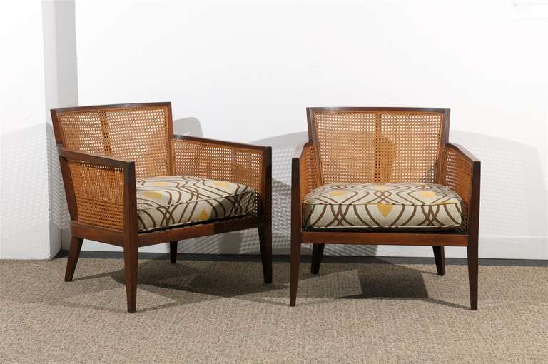 A rare pair of walnut and cane lounge/club chairs by Harvey Probber, circa 1960's. Striking, comfortable chairs with wonderful detail. Excellent restored condition, with new upholstery. The price noted is for the pair.TOM ROBINSON MODERN at TRAVIS &