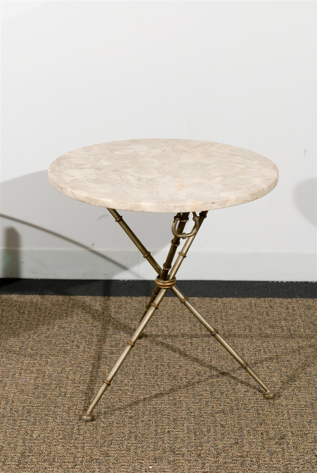 Tripod iron faux bamboo side table with creamy white marble top.
Base in burnished silver and bronze patina with loose hanging rings.