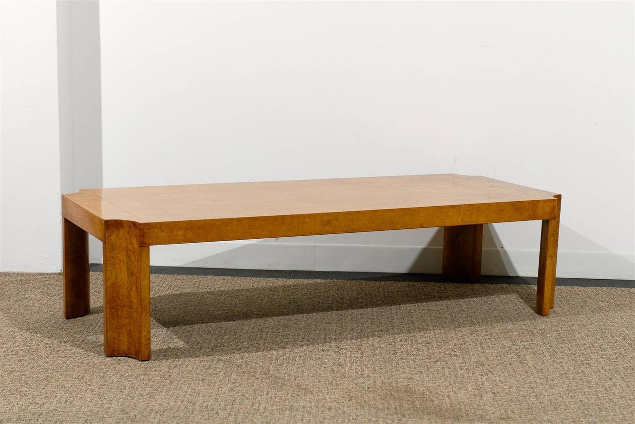 Extremely sophisticated, sleek burl wood coffee table supported by solid concave legs in a beautiful soft honey color,
Italy, circa 1970.