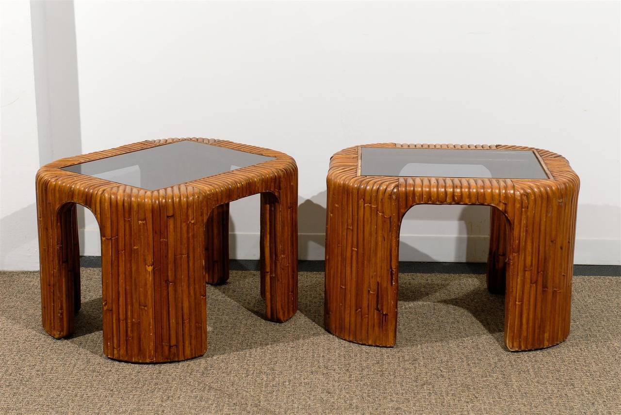 Chic pair of Mid-Century bent bamboo side tables with inserted smoked glass tops.