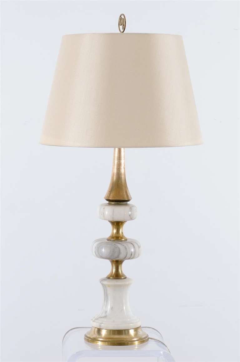 A Exceptional pair vintage lamps comprised of marble and solid brass components. Wonderful Scale and Design. While the pieces are unmarked, they are reminiscent of Marbro lamp production of the early 1960's. Heavy, well made pieces that will make a
