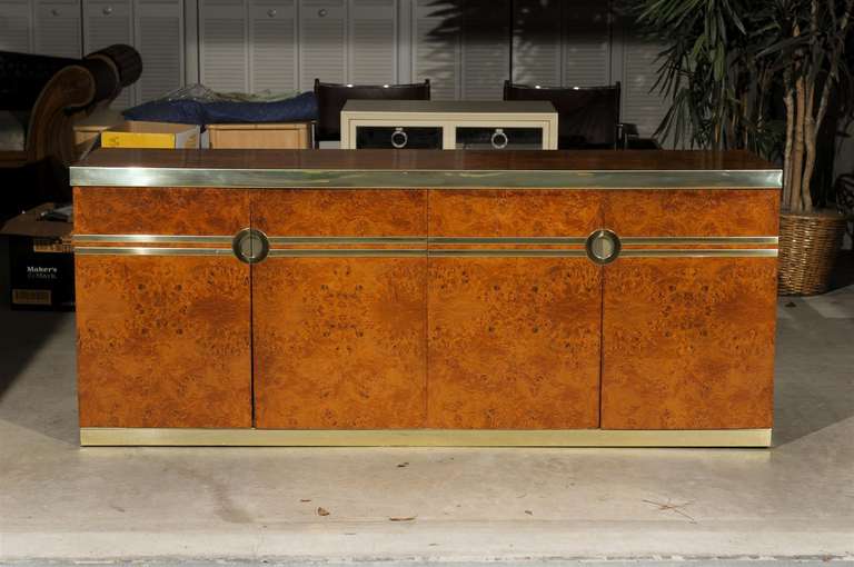 Handsome burl and brass buffet/credenza by Pierre Cardin, circa 1970's. Book matched Olive Wood with lovey brass detail. Pure Sophistication ! Excellent Vintage Condition, brass with wonderful patina. Retains the Maker mark. TOM ROBINSON MODERN at