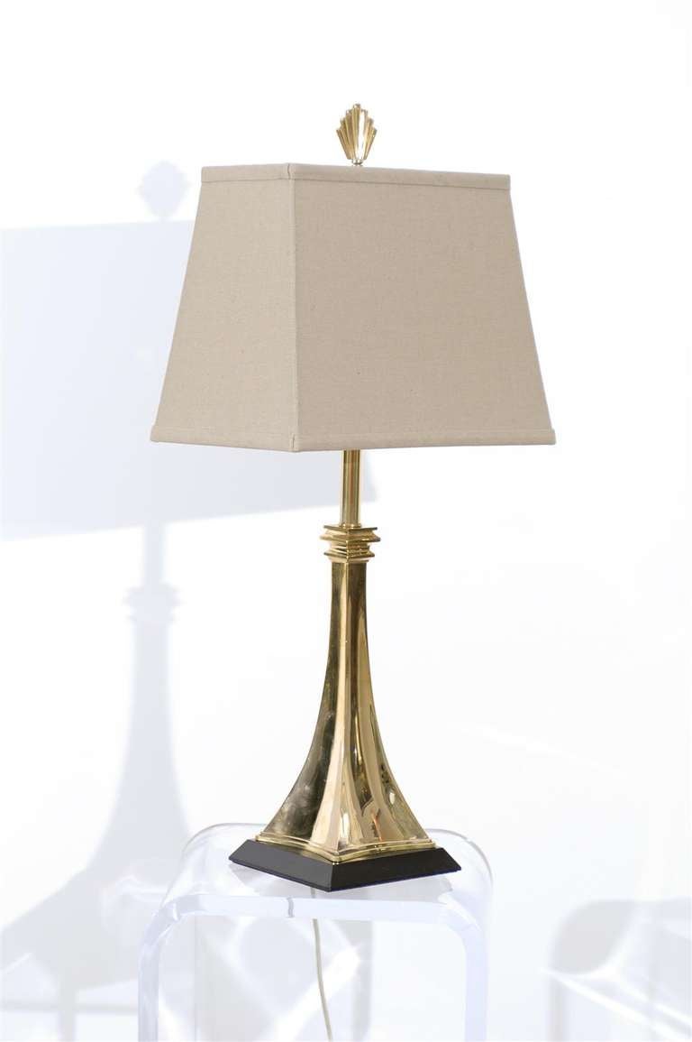 A Stunning pair of Modern solid brass lamps on a black lacquer wood base, circa 1960. Exquisite Jewelry ! Excellent Restored Condition, rewired with clear cord and complete with new soft gray linen shades. Brass with lovely patina, wood base has