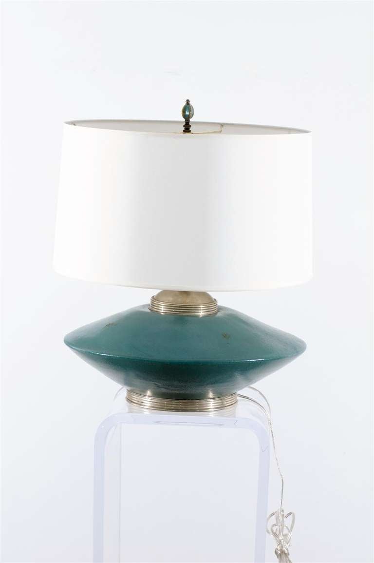A Very Unusual pair of ceramic lamps by Orno, circa 1950's. Beautiful turquoise color with silver accents. Exquisite Jewelry ! Excellent Restored Condition, rewired with clear cord and complete with new silk shades. Height noted is to the top of the